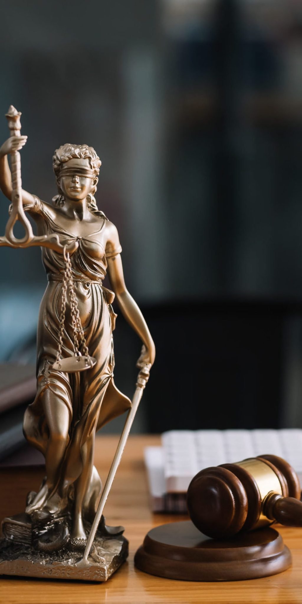 Statue of lady justice on desk of a judge or lawyer.